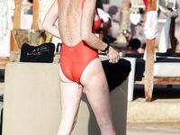 Lindsay Lohan caught by paparazzi in red swimsuit